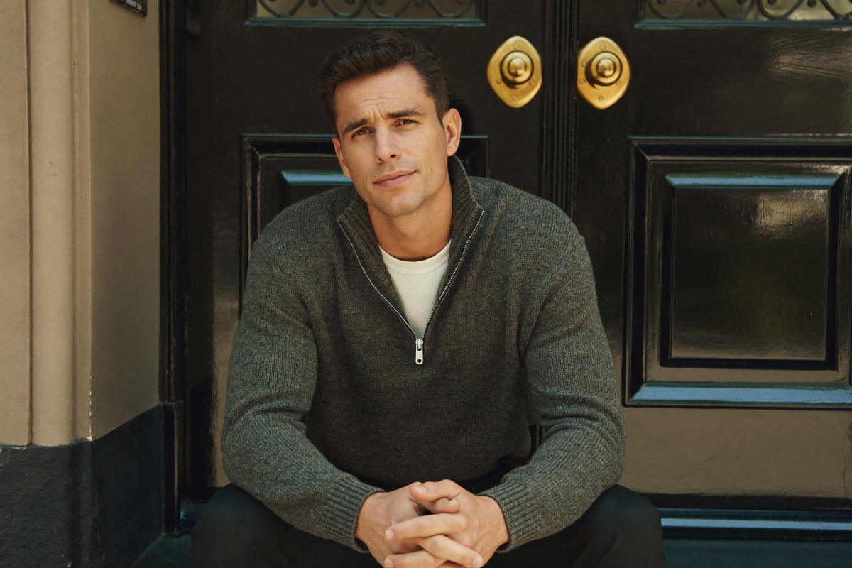 Man in charcoal knit on a Kensington doorstep