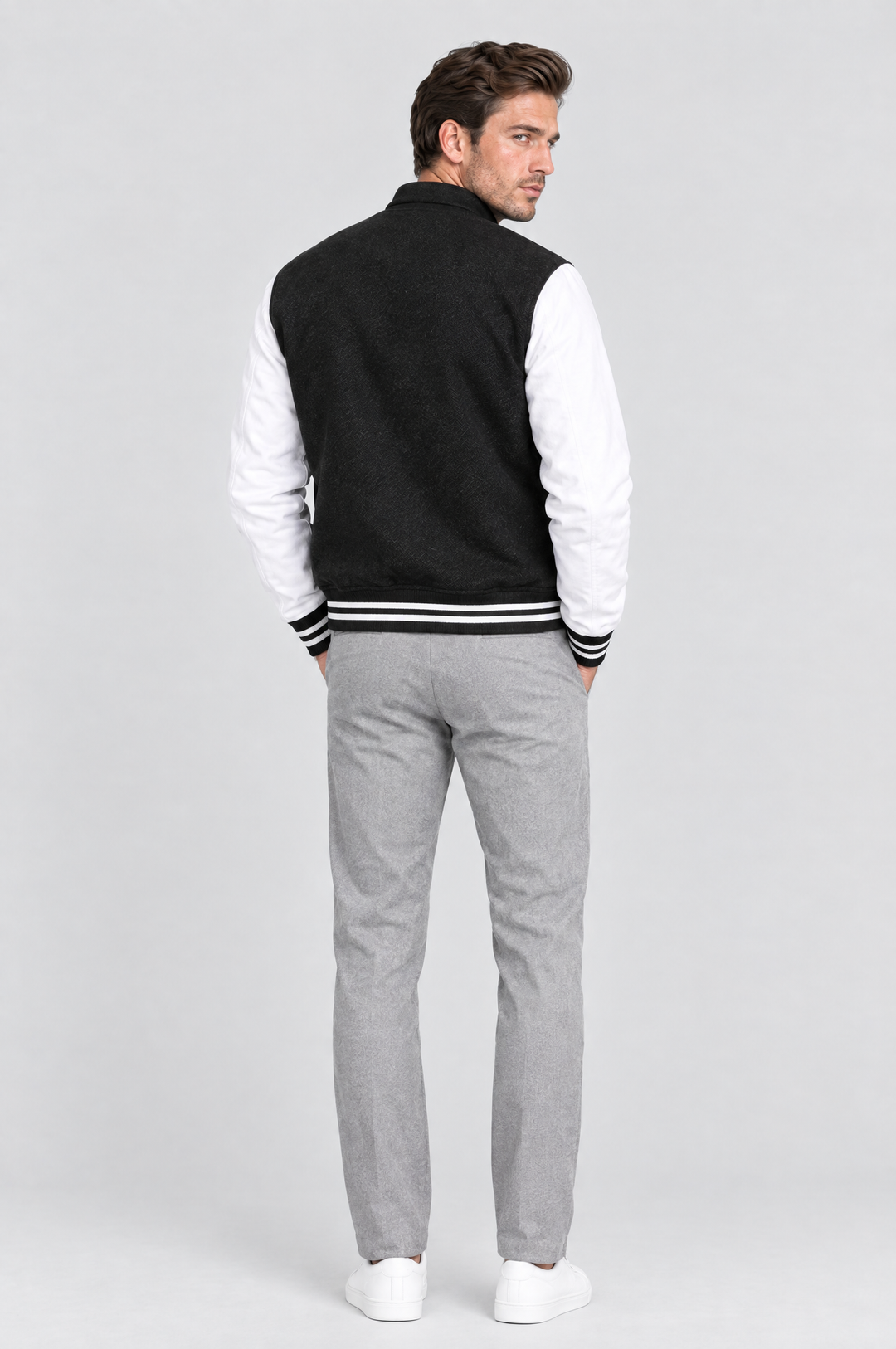The Islington Varsity Jacket in Black, on model, back view