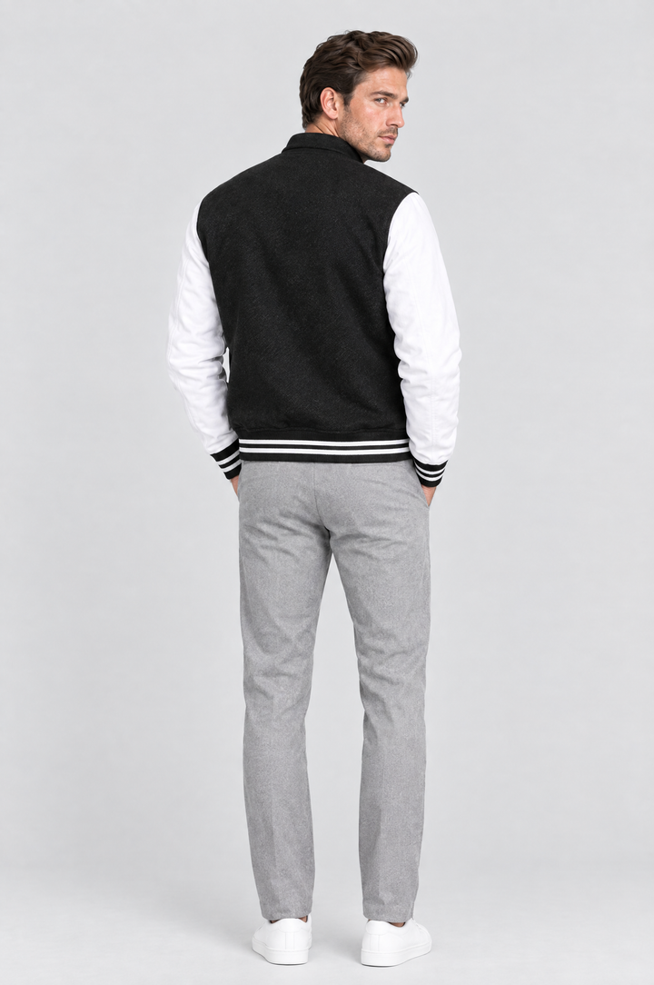 The Islington Varsity Jacket in Black, on model, back view
