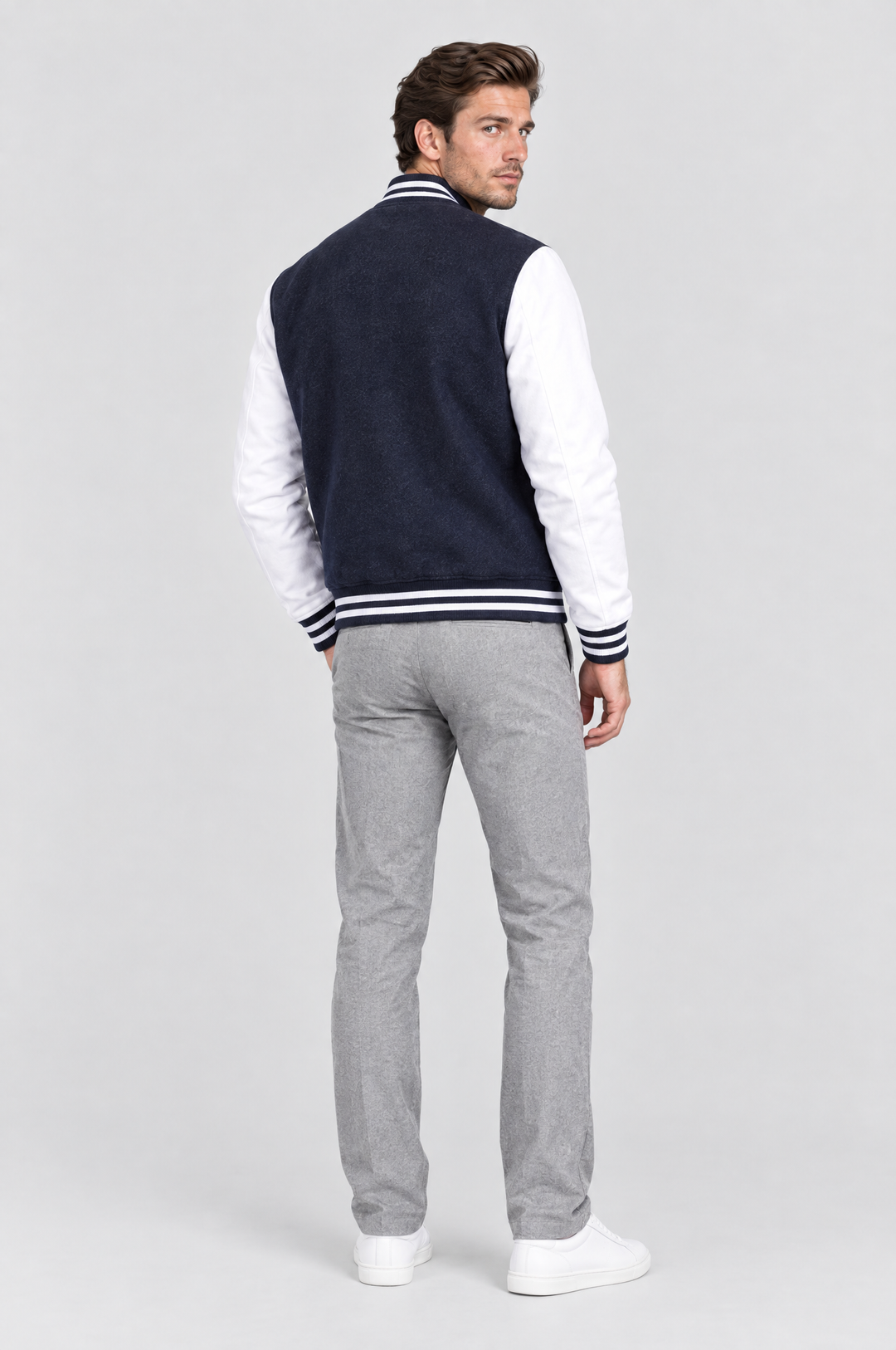 The Islington Varsity Jacket in Navy, on model, back view