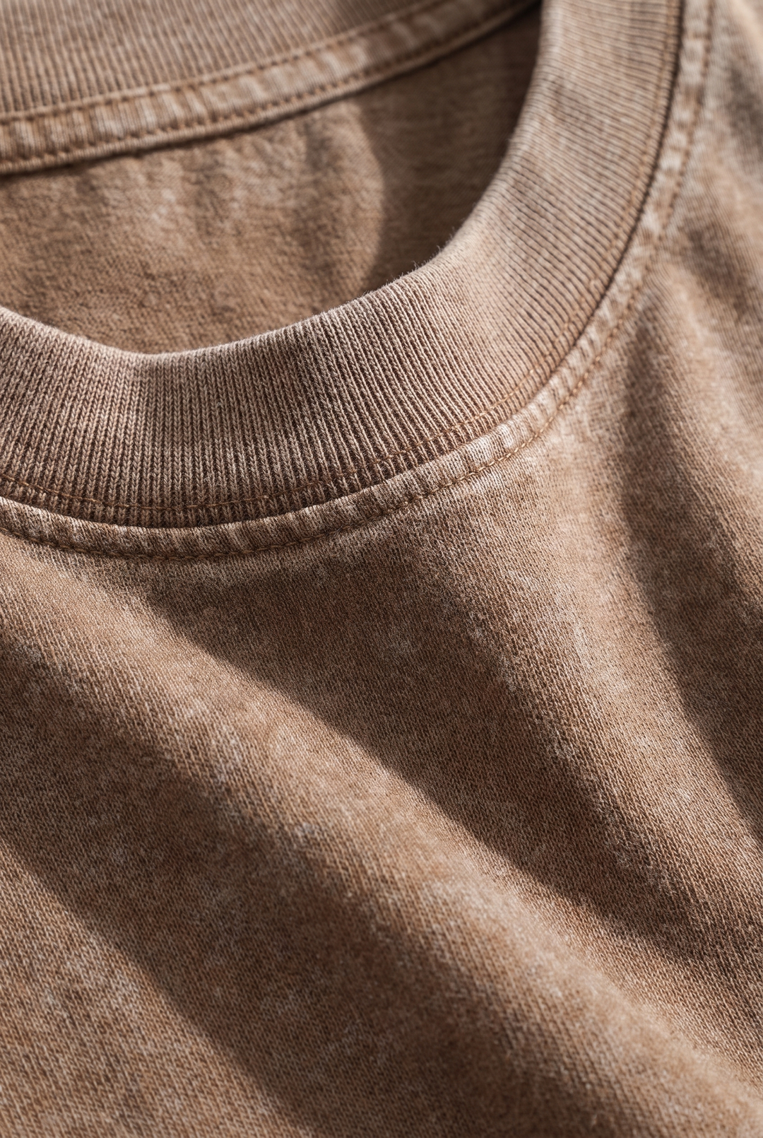 Close-up of the heavyweight cotton and ribbed collar on The Portobello acid wash tee