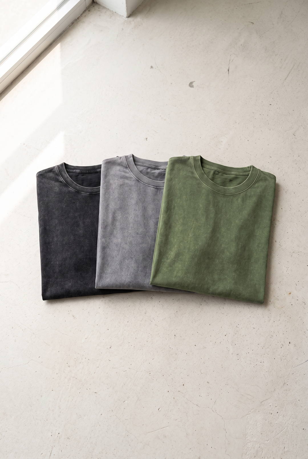 The Portobello acid wash tee folded in washed black, grey and olive – mix any 3 and save 20%